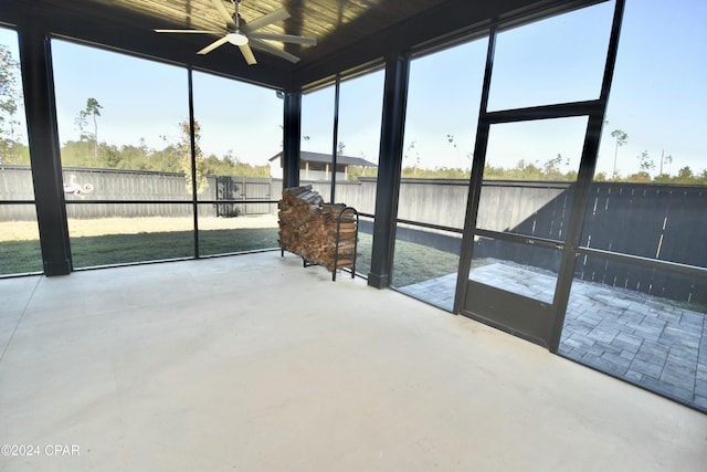 sunroom / solarium with plenty of natural light and ceiling fan