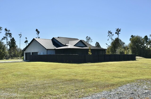 view of home's exterior featuring a garage and a lawn