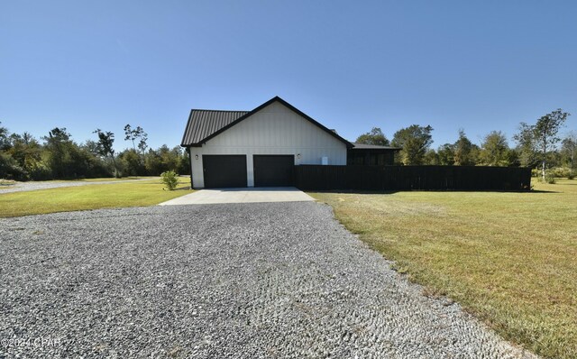 view of side of property with a lawn and a garage