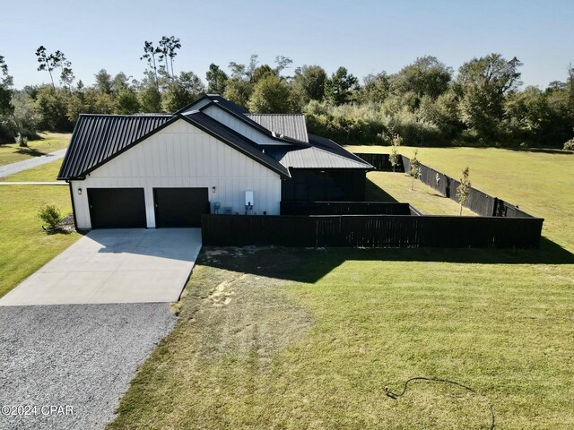 exterior space featuring a lawn and a garage