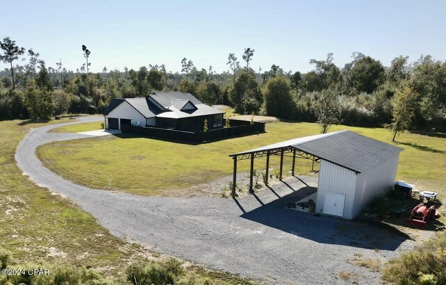 view of home's community featuring a yard and an outdoor structure