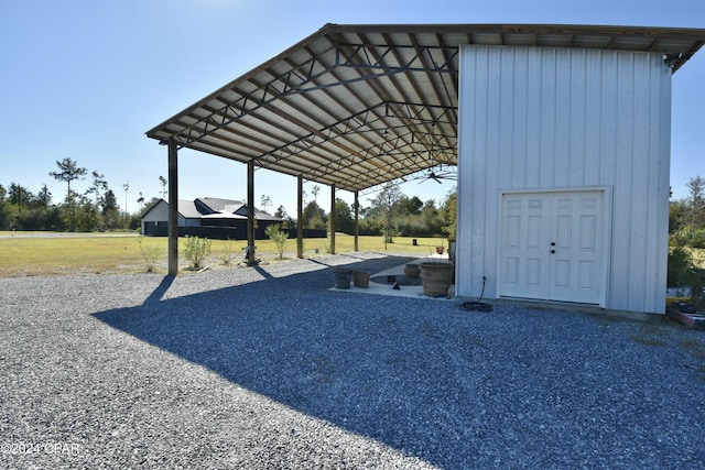 view of car parking with a carport and a yard