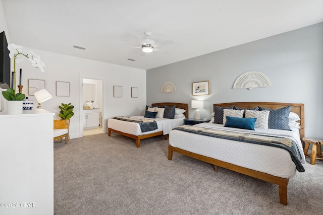 carpeted bedroom featuring connected bathroom and ceiling fan