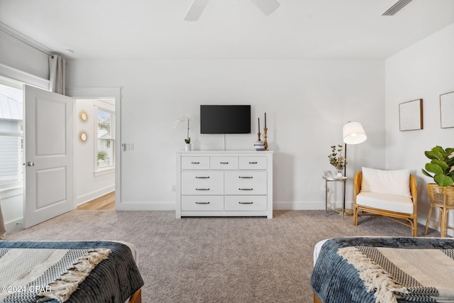 bedroom with ceiling fan and light colored carpet