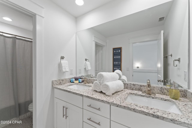 bathroom with vanity and toilet