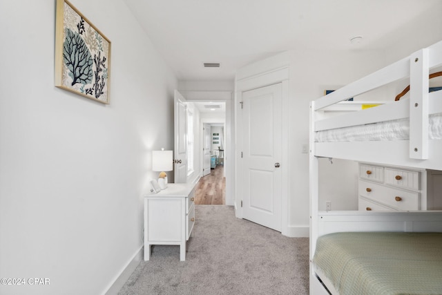 bedroom featuring light carpet