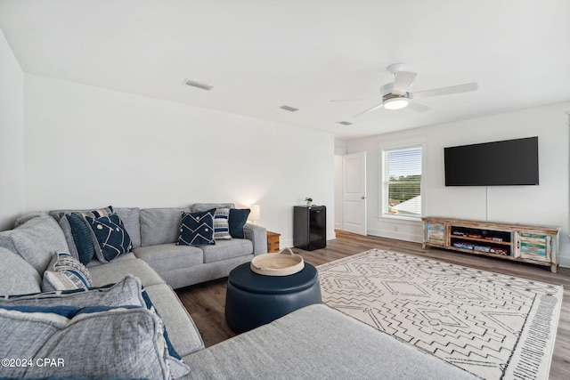 living room featuring hardwood / wood-style flooring and ceiling fan