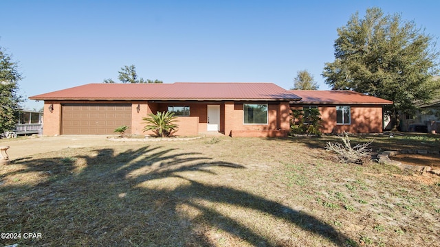 ranch-style home with a front yard and a garage