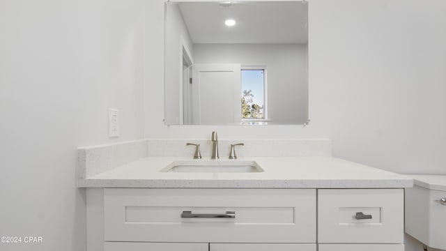 bathroom featuring vanity and toilet