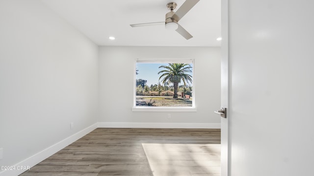 empty room featuring hardwood / wood-style floors and ceiling fan