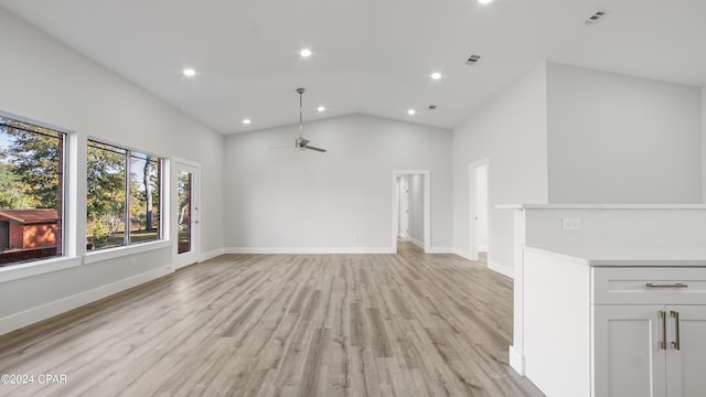 unfurnished living room featuring light wood-type flooring, high vaulted ceiling, and ceiling fan