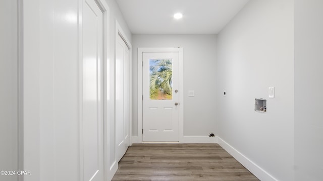 washroom featuring light hardwood / wood-style flooring, washer hookup, and hookup for an electric dryer