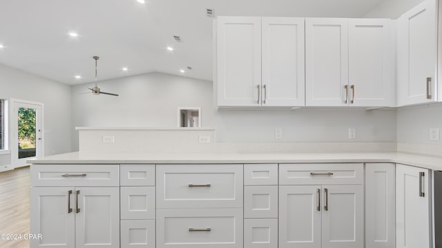 kitchen featuring ceiling fan, light hardwood / wood-style flooring, white cabinets, and vaulted ceiling