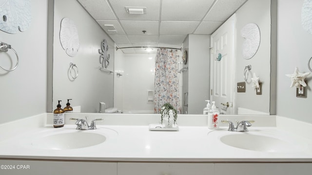 full bathroom featuring vanity, a paneled ceiling, toilet, and shower / tub combo with curtain