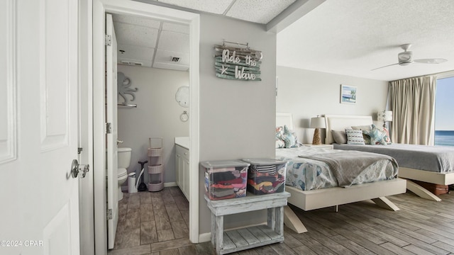 bedroom featuring hardwood / wood-style flooring, a paneled ceiling, and ceiling fan