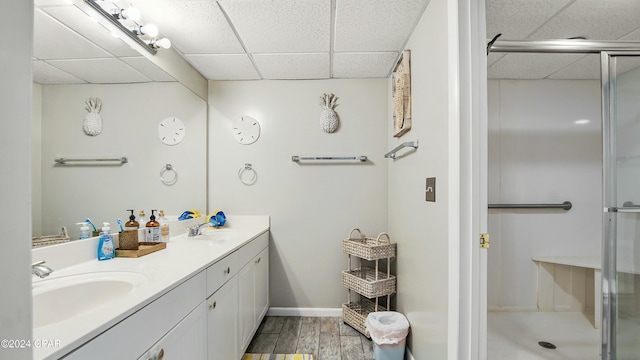 bathroom featuring hardwood / wood-style floors, vanity, a paneled ceiling, and an enclosed shower