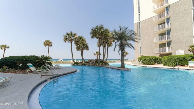 view of swimming pool featuring a water view