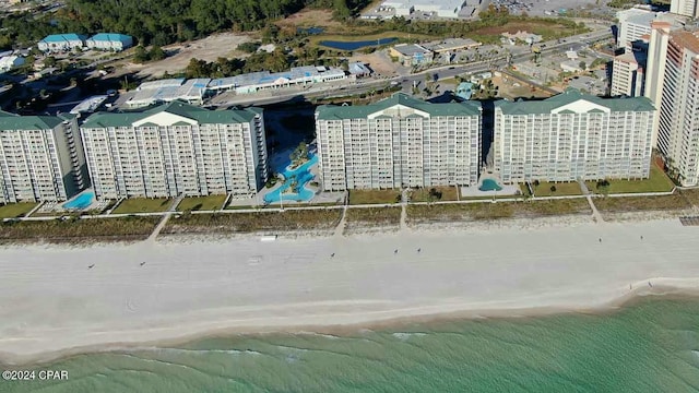 drone / aerial view with a water view and a view of the beach