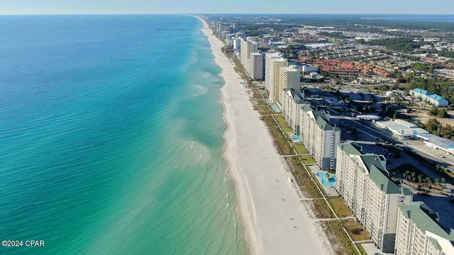 bird's eye view featuring a water view and a beach view