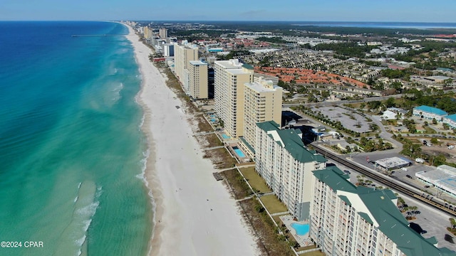 drone / aerial view with a water view and a beach view