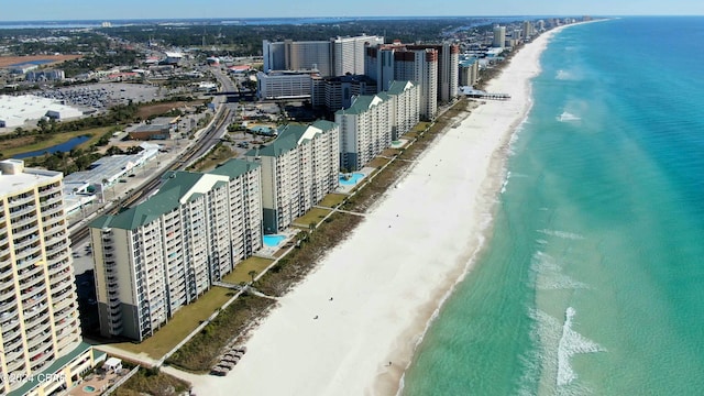 bird's eye view with a water view and a beach view