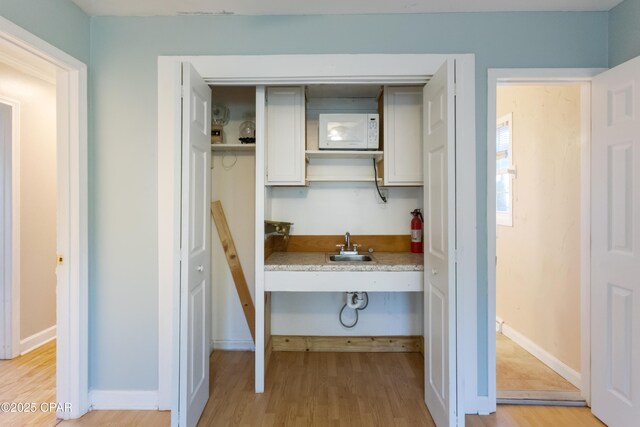 kitchen featuring sink and light hardwood / wood-style flooring