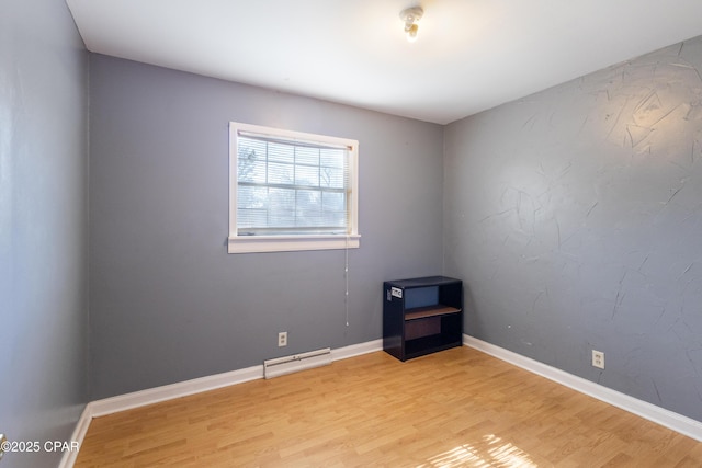 empty room with light hardwood / wood-style flooring