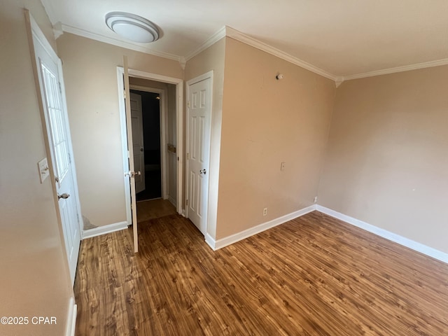 unfurnished room featuring ornamental molding and hardwood / wood-style floors