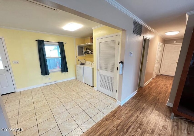 kitchen featuring light hardwood / wood-style flooring, ornamental molding, and independent washer and dryer