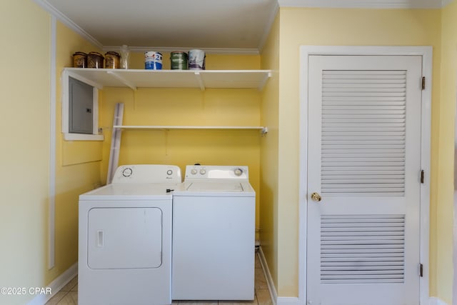 laundry area with washing machine and dryer, ornamental molding, light tile patterned floors, and electric panel