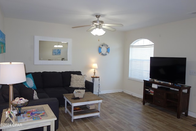 living room featuring wood-type flooring and ceiling fan