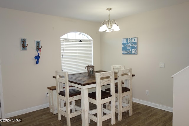 dining room featuring dark hardwood / wood-style floors and a notable chandelier