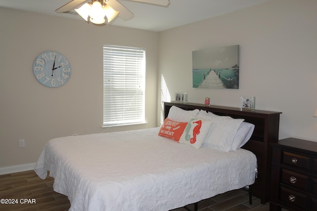 bedroom with ceiling fan and dark wood-type flooring