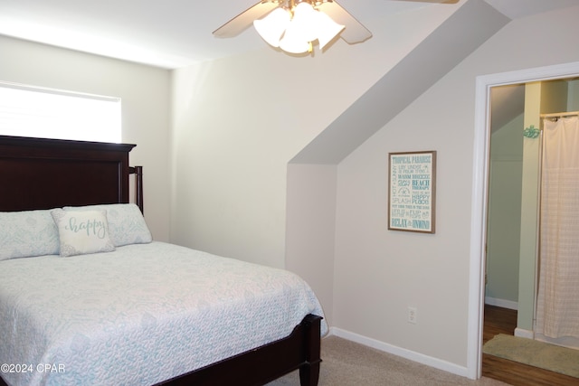 carpeted bedroom with ceiling fan and lofted ceiling