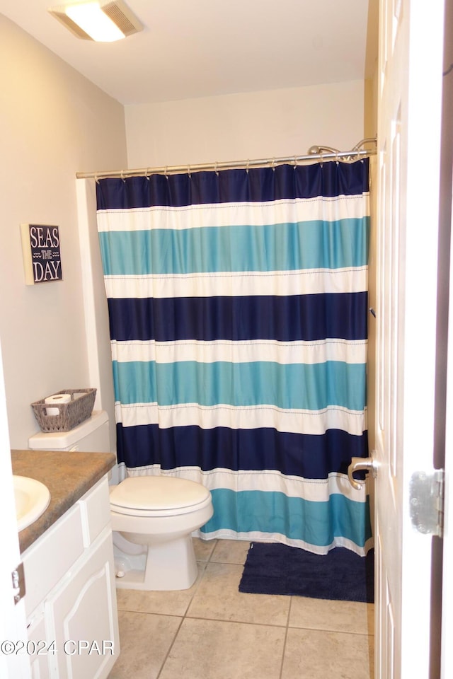 bathroom with tile patterned floors, vanity, a shower with shower curtain, and toilet