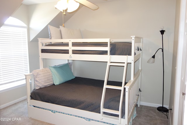 carpeted bedroom featuring multiple windows and ceiling fan