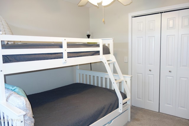 carpeted bedroom featuring a closet and ceiling fan