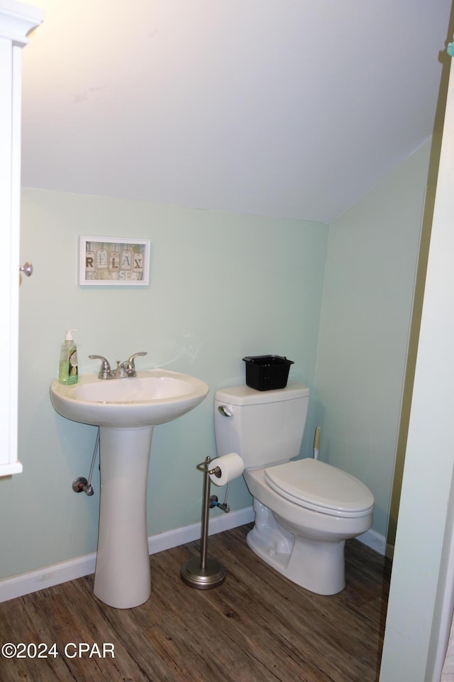 bathroom featuring sink, toilet, and hardwood / wood-style flooring