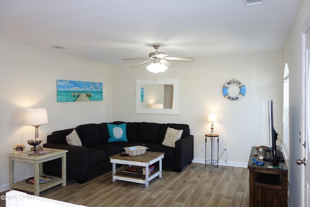 living room with hardwood / wood-style floors and ceiling fan