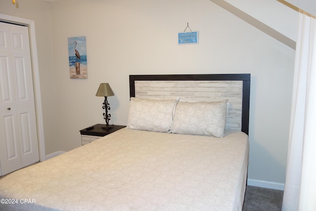 carpeted bedroom featuring lofted ceiling