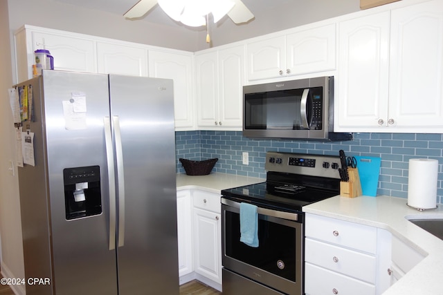 kitchen featuring backsplash, ceiling fan, white cabinets, and stainless steel appliances