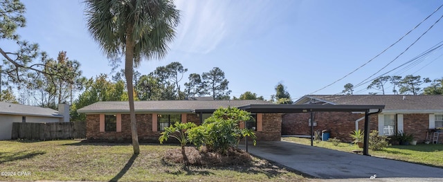 single story home with a front lawn and a carport