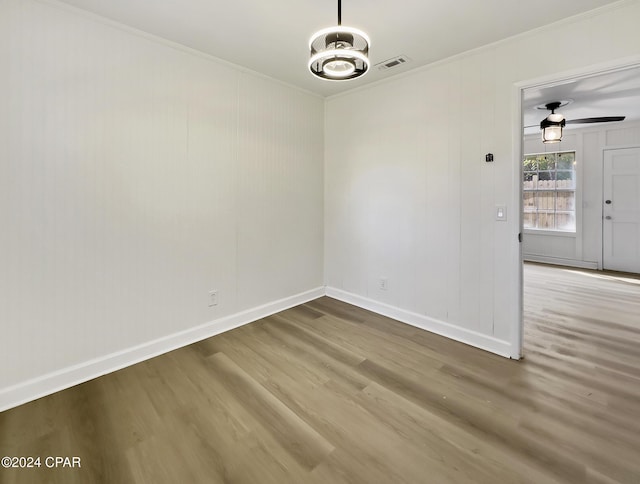 unfurnished room with crown molding, hardwood / wood-style floors, and ceiling fan