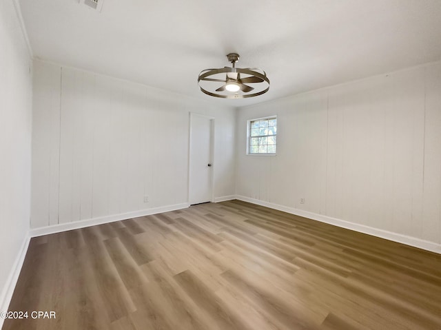 empty room with ceiling fan and hardwood / wood-style floors