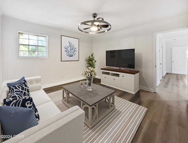 living room with ceiling fan and dark hardwood / wood-style flooring