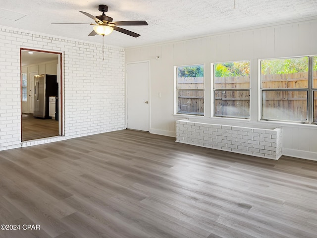 spare room with wood-type flooring, a textured ceiling, and ceiling fan