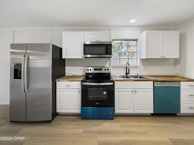 kitchen featuring sink, white cabinets, wooden counters, and appliances with stainless steel finishes