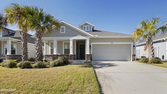 craftsman-style home featuring a garage and a front lawn