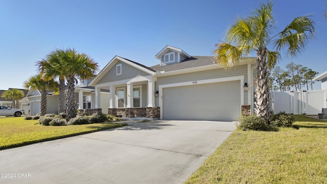 view of front of property with a garage and a front lawn