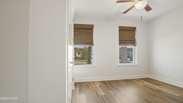 unfurnished room with hardwood / wood-style floors and ceiling fan